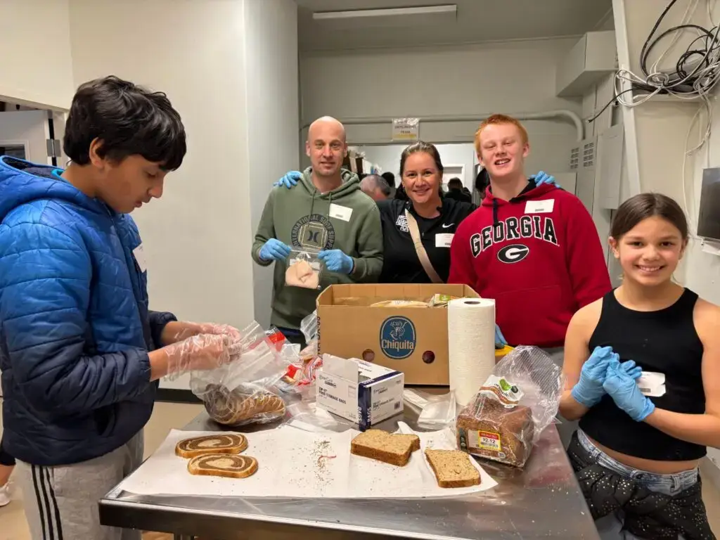 image of volunteers at Meals by Grace (a ministry of Ministries of Grace). They are bpart of the community support that helps break the cycle of poverty.