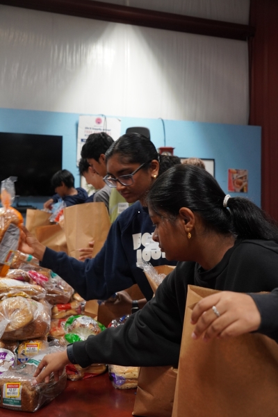 Image of Ministries of Grace volunteers preparing food boxes for families strugging with medical needs.