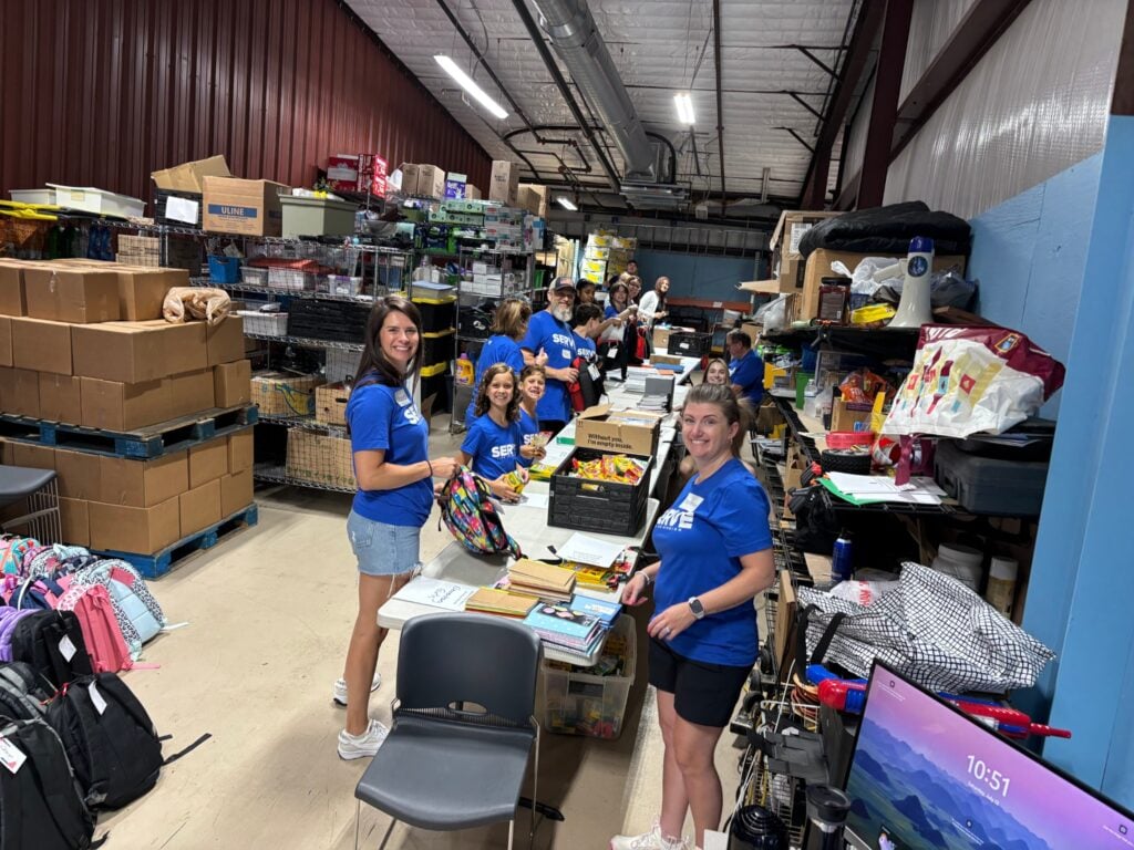 Image of people packing backpacks with school supplies for families in need at Grace Cares.