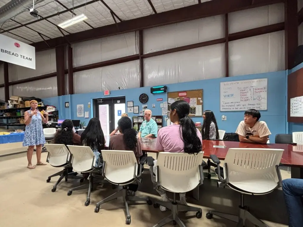 Image of Suellen Daniels leading a training for volunteers representing Volunteer Ministry Opportunities: How Volunteers Carried the Mission Further Than Ever Before.