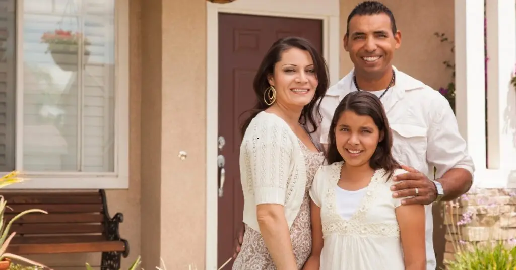 Image of a happy hispanic family who received help from Ministries of Grace representing the spiritual joy of generosity.